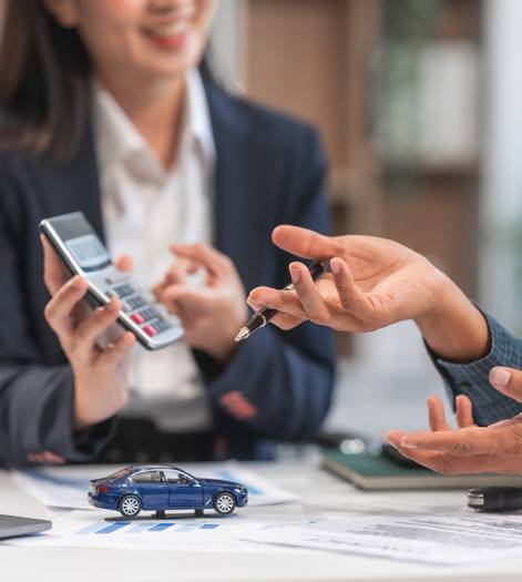 Two individuals are making calculations